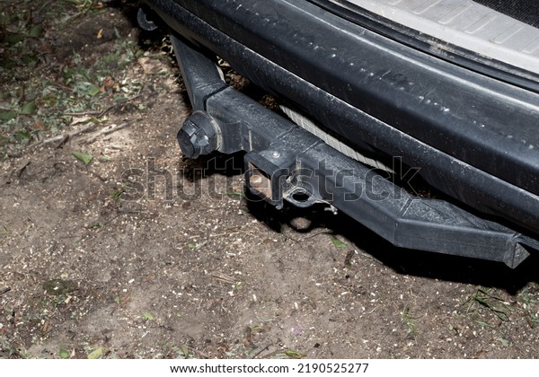 Iron hitch on a car for towing a trailer.\
Device for transportation.
