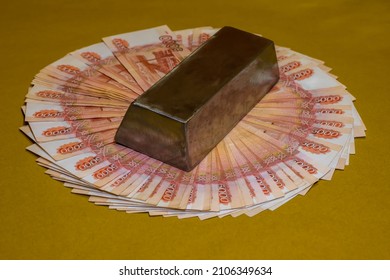 An Iron Ingot Lies On A Fan Made Of 5000 Rubles Bills. Background Picture.