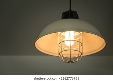 Iron lighting lamp in classic style is glowing in warming shade ligth. Interior decoration object, selective focus. - Powered by Shutterstock