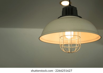 Iron lighting lamp in classic style is glowing in warming shade ligth. Interior decoration object, selective focus. - Powered by Shutterstock