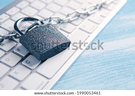 iron lock and chain on the keyboard. cyber defense