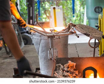 iron metal in laddle removing slag by operator ; industrial background