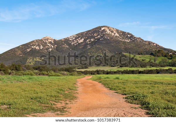 Iron Mountain, the southernmost peak\
in a small mountain complex dividing the city of Poway from the\
semi-rural community of Ramona in San Diego\
County.