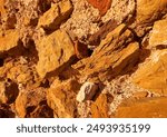 Iron ore, background, texture. Stone close-up. Ferrous metal ore. Iron ore mining, Hematite (Fe2O3) held. Relief of earth after excavations in open pit. Extraction of minerals and minerals in quarry