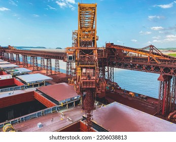 Iron Ore Conveyor Loading Cargo in Cape Size Bulk Carrier - Shutterstock ID 2206038813