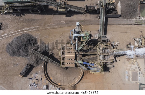 Iron raw materials recycling pile, work\
machines. Metal waste junkyard. View from\
above.