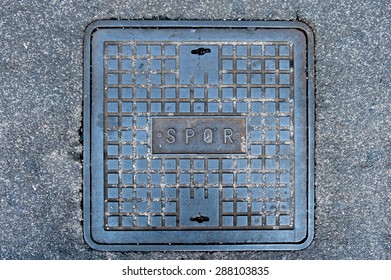 Iron Roman Manhole Cover On The Street With Spqr Word