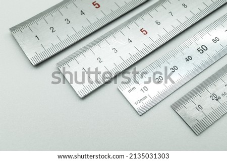 Iron ruler close-up on a white background. Stainless steel ruler. Working tools made of metal and stationery. Selective focus, isolated on white