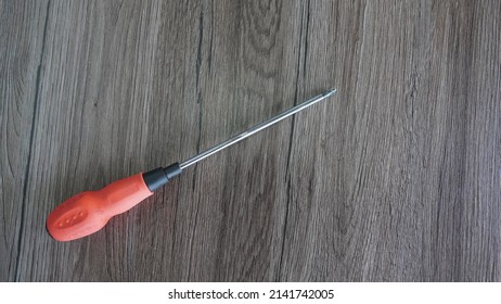 Iron Screwdriver In Red On A Wooden Work Bench