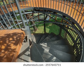 iron spiral staircase with black steps and black iron pipe railing
 - Powered by Shutterstock