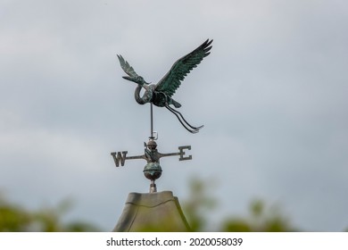 iron weathervane in the shape of a stork with a blurred background an instrument used for showing the direction of the wind