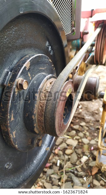 the iron\
wheel of a plowing machine diesel\
engine