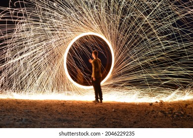 Iron wool circle drawing light fireworks. Burning Steel Wool spinning, Trajectories of burning sparks at night. Movement light effect, steel wool fire hoop. long exposure light painting, Pyrotechnic - Powered by Shutterstock