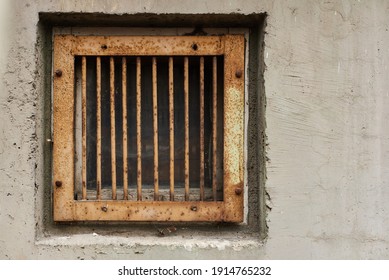 Iron-barred window in suburb of Eastern Europe garage fear of theft first floor of old apartment building rust and aged wall texture - Powered by Shutterstock