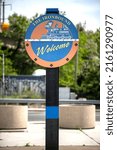 The Ironbound Welcome Sign welcomes visitors to Newark, showcasing vibrant community spirit along a bustling street.