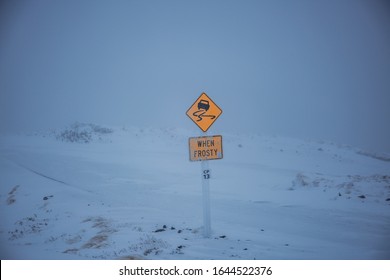 Ironic sign in extreme snow conditions on top of the road at mountain Ruapehu, New Zealand
