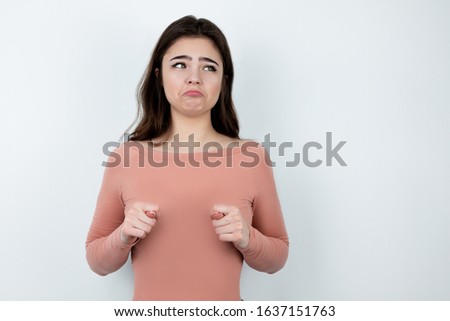 ironic young woman showing diddly-squat sign instead of breast, bodypositive concept
