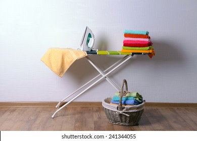 Ironing Board With Laundry On Light Background