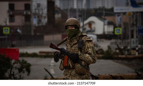 Irpin, Kyiv region, Ukraine - March 3 2022: Ukrainian soldier on duty near the occupied town of Irpin, a suburb of Kiyv, during attacks by the Russian army. Russian full-scale invasion in Ukraine. 