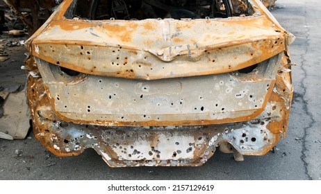 Irpin, rusty shelled car, the aftermath of the Russian army's invasion of Ukraine. War in Ukraine