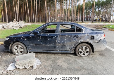 IRPIN, UKRAINE - April 27, 2022: Side Part Of The Civil Car Which Was Shot Up By Russian Soldiers During Evacuation Of Unarmed Peoples From War Zone In Russian Invasion Of Ukraine, Car Graveyard 
