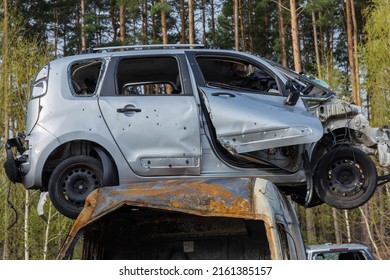 IRPIN, UKRAINE - April 27, 2022: Side Part Of The Civil Car Which Was Shot Up By Russian Soldiers During Evacuation Of Unarmed Peoples From War Zone In Russian Invasion Of Ukraine, Car Graveyard 
