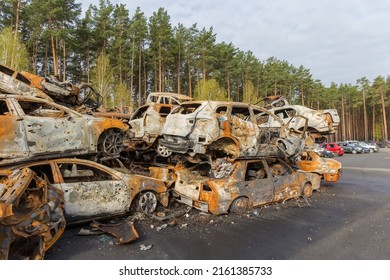 IRPIN, UKRAINE - April 27, 2022: Remains Of The Civil Cars Which Was Shot Up And Burned Out By Russian Soldiers During Evacuation Of Unarmed Peoples From War Zone In Russian Invasion, Car Graveyard 
