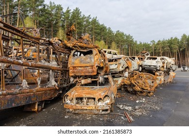 IRPIN, UKRAINE - April 27, 2022: Remains Of The Civil Cars Which Was Shot Up And Burned Out By Russian Soldiers During Evacuation Of Unarmed Peoples From War Zone In Russian Invasion, Car Graveyard 
