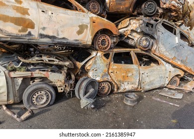 IRPIN, UKRAINE - April 27, 2022: Remains Of The Civil Cars Which Was Shot Up And Burned Out By Russian Soldiers During Evacuation Of Unarmed Peoples From War Zone In Russian Invasion, Car Graveyard 
