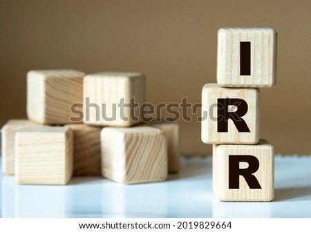IRR (Internal Rate of Return) - acronym nadrevyannye cubes on a brown background