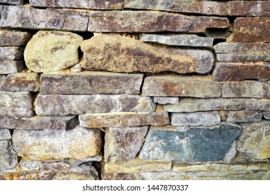 Irregular decorative color stone wall texture - Shutterstock ID 1447870337