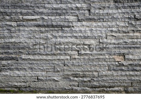 Irregular dry gray stone wall 