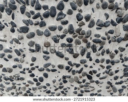 irregular pebbles embedded in the surface of the tile