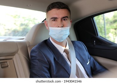 Irresponsible businessman using protective mask the wrong way