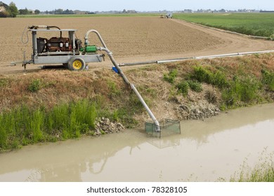 A Irrigation Pump Sucks Water From The Canal To Irrigate The Fields