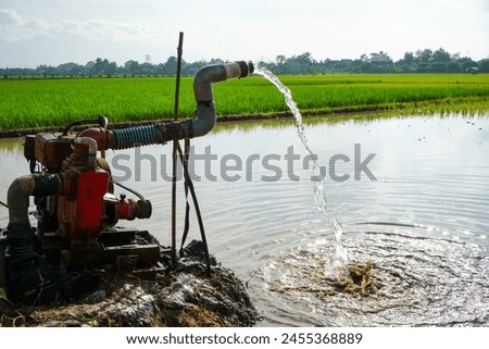 Irrigation of rice fields using pump wells with the technique of pumping water from the ground to flow into the rice fields. The pumping station where water is pumped from a irrigation canal system.