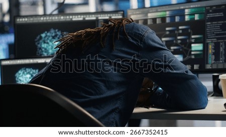 Irritated data center engineer punching desk, irked by glitches while using algorithms to analyze datasets. Mad server hub developer raging, annoyed by malfunctioning AI neural networks, camera B