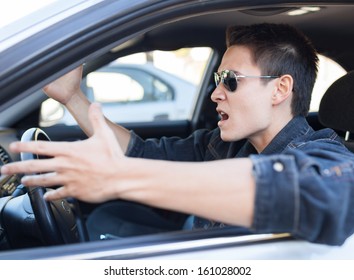 Irritated Driver. Irritated Young Male Driving A Car