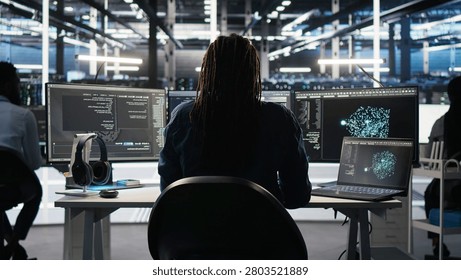 Irritated high tech server room technical specialist punching desk, irked by glitches.