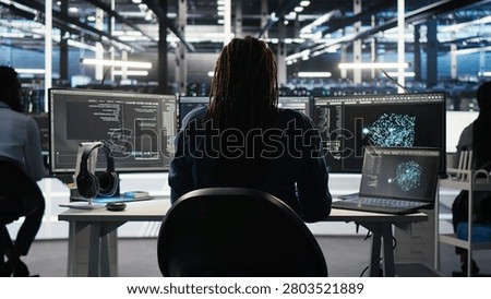 Irritated high tech server room technical specialist punching desk, irked by glitches.
