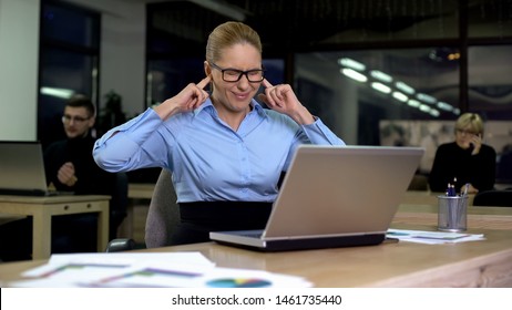 Irritated Lady Closing Ears With Fingers, Noisy Colleagues Distracting From Work