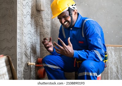 Irritated Plumber While Fixing Or Tighting Leakage At Construction Site - Concept Of Work Pressure, Frustration And Fear Of Job Loss