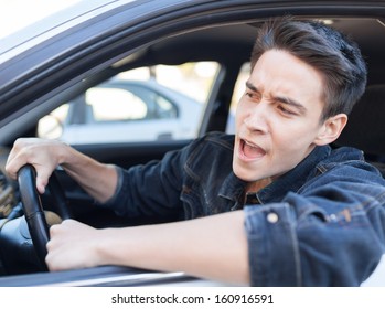 Irritated Young Man Driving A Car. Irritated Driver