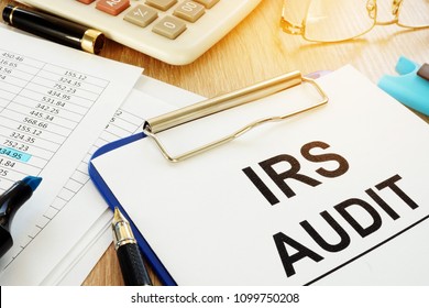 IRS Audit Documents With Clipboard On A Desk.