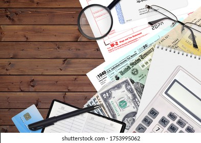 IRS form 1040 Individual income tax return and W-2 wage and tax statement lies on office table and ready to fill. U.S. Internal revenue services paperwork concept. Time to pay taxes