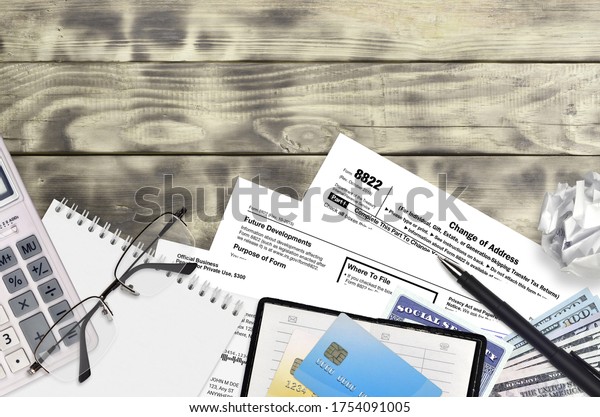 IRS form 8822 Change of\
Address lies on flat lay office table and ready to fill. U.S.\
Internal revenue services paperwork concept. Time to pay taxes in\
United States