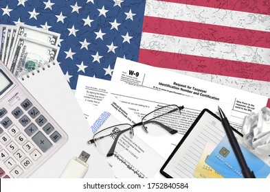IRS form W-9 Request for taxpayer identification number and certification lies on flat lay office table and ready to fill. U.S. Internal revenue services paperwork concept. Time to pay taxes - Shutterstock ID 1752840584