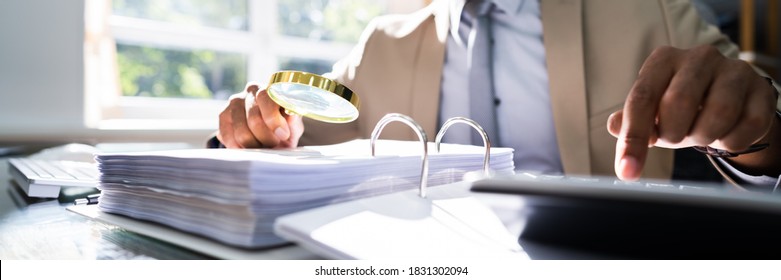 IRS Tax Audit. African Auditor Doing Debt Fraud Inspection - Shutterstock ID 1831302094