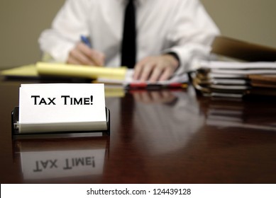 IRS Tax Auditor Man Sitting At Desk With Business Card