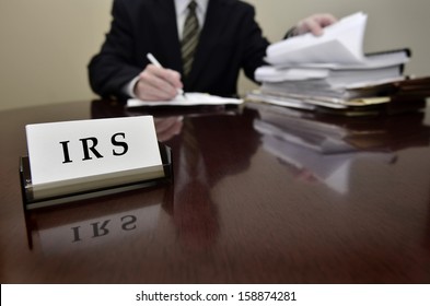 IRS tax auditor man with a stern or mean expression